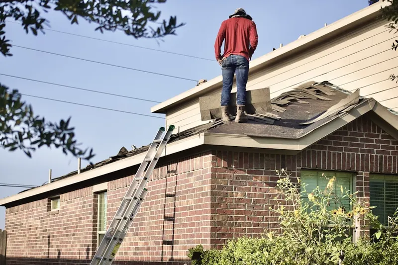Professional roofer working on a residential roof in Branchport